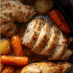 Garlic Butter Chicken and Veggies: Rustic kitchen scene featuring a slow cooker with garlic butter chicken, carrots, and potatoes, warm lighting
