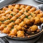 Plated slice of Tater Tot Casserole with ground beef and crispy tots