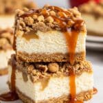 Layering caramel apple cheesecake bars with crust, cheesecake, apple topping, and crumble.​