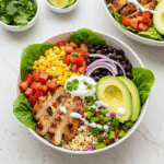 Close-up Chicken Avocado Burrito Bowl with creamy avocado and zesty lime, perfect for meal prep and quick lunches.tasty