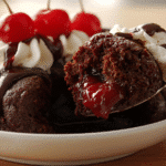 Chocolate cherry dump cake in white ceramic dish with rich chocolate cake and cherry pie filling topped with melted butter.