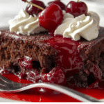 Overhead shot of entire chocolate cherry dump cake in baking dish, showing chocolate and cherry contrast.