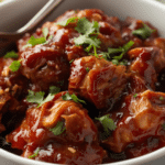 Alt Text: A bowl of juicy Crockpot BBQ chicken breasts seasoned with garlic and onion powder.