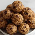 Hands holding a peanut butter protein ball.