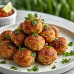 A platter of juicy air fryer turkey meatballs with a side of marinara sauce.