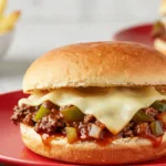 Cheesesteak Style Sloppy Joes:A Gourmet Sloppy Joe Recipe served with sautéed peppers and onions, showcasing a ground beef cheese steak sandwich style dinner.