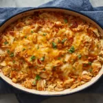 Rotisserie chicken hash brown casserole served on a plate with a side of green beans.